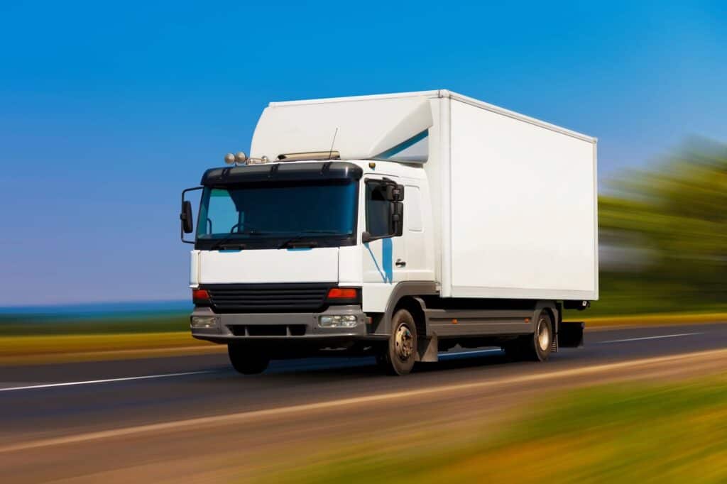 A small moving truck on the motorway