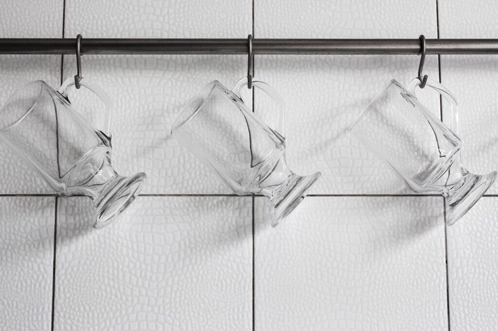 Glass mugs on hooks
