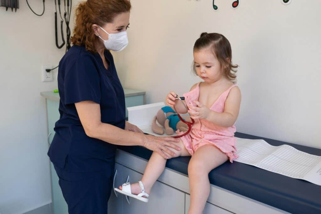 A young child at a clinic with a paediatrician