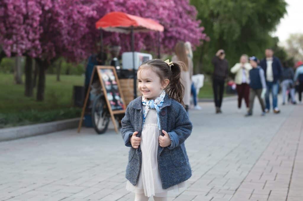 A little girl walking in the park in springtime