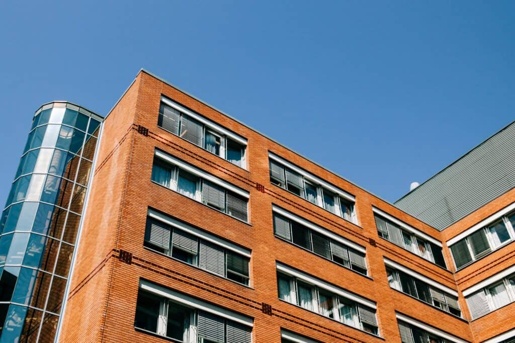 A low-angle shot of a modern brick residential building
