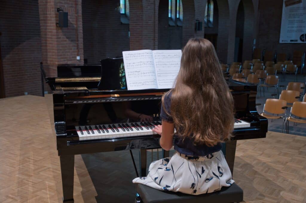 A teenage girl playing the piano