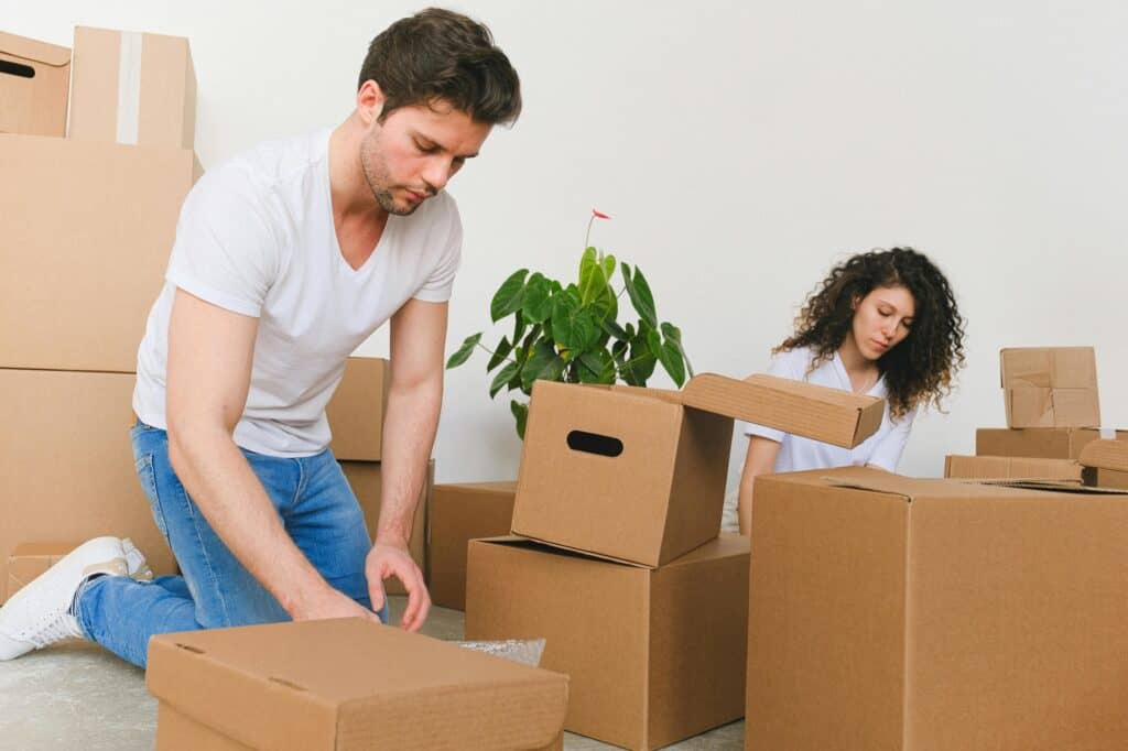 A couple reusing cartons for the house move