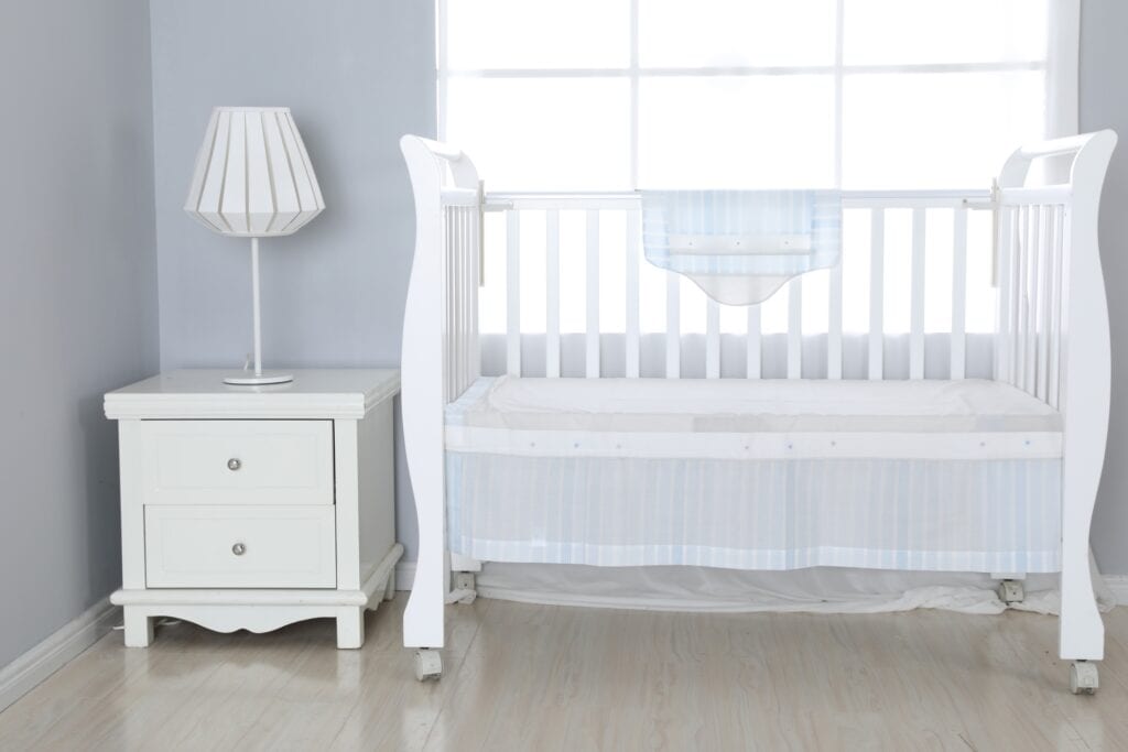A plain white baby cot