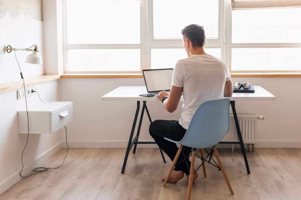 A man at his newly setup home office after the move