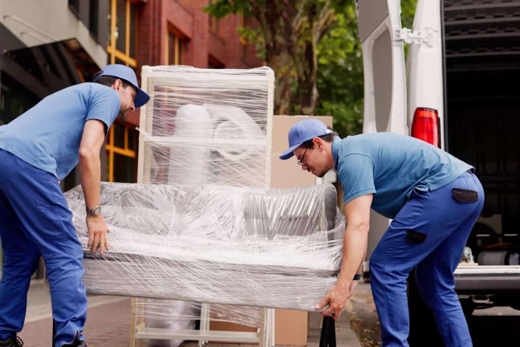 Man and van crew loading furnitures into the van